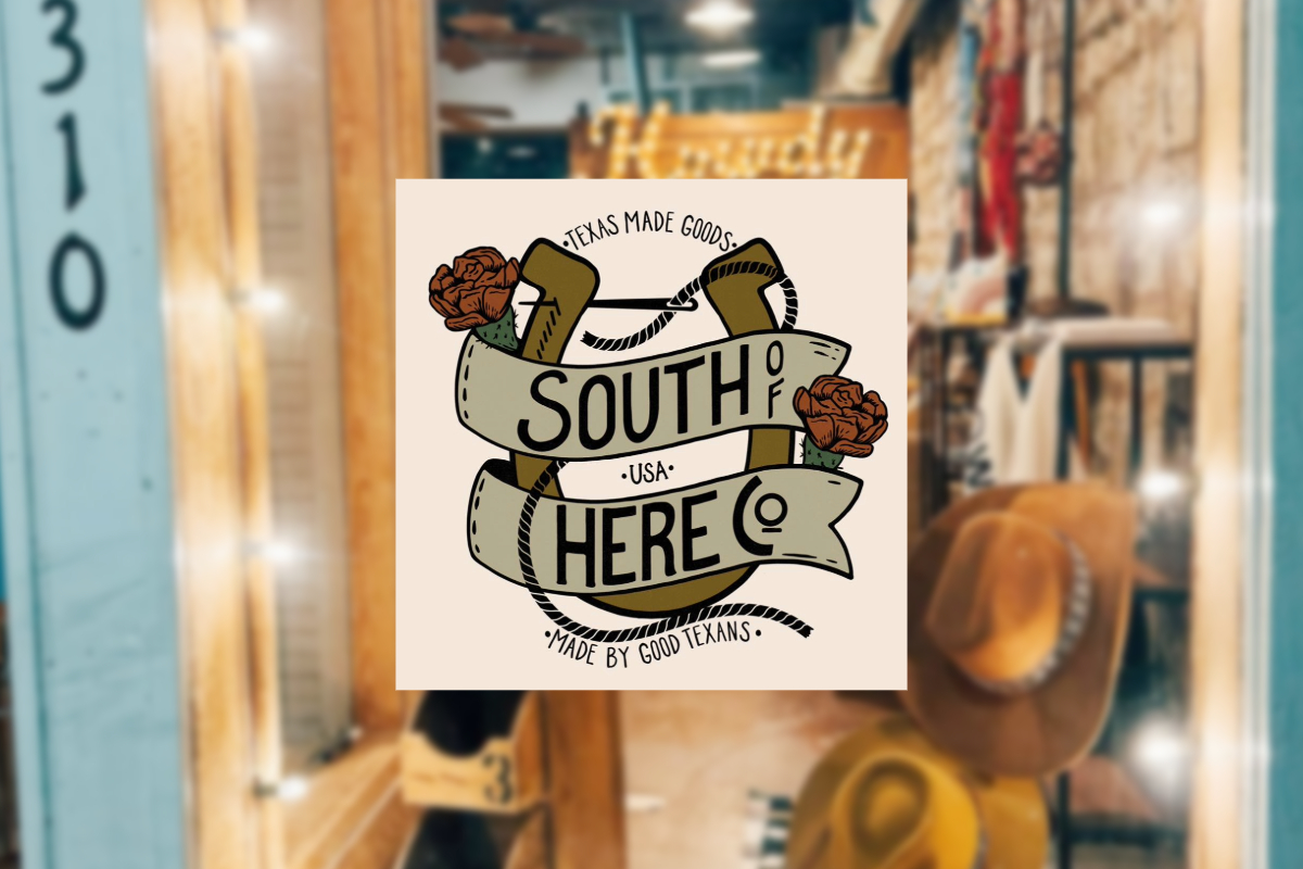 A graphic overlays a blurred shop scene, featuring a ribbon reading: “Texas Made Goods, South of Here Co., USA, Made by Good Texans,” accented with two roses. South of Here Co. hats and rustic decor can be seen in the background.