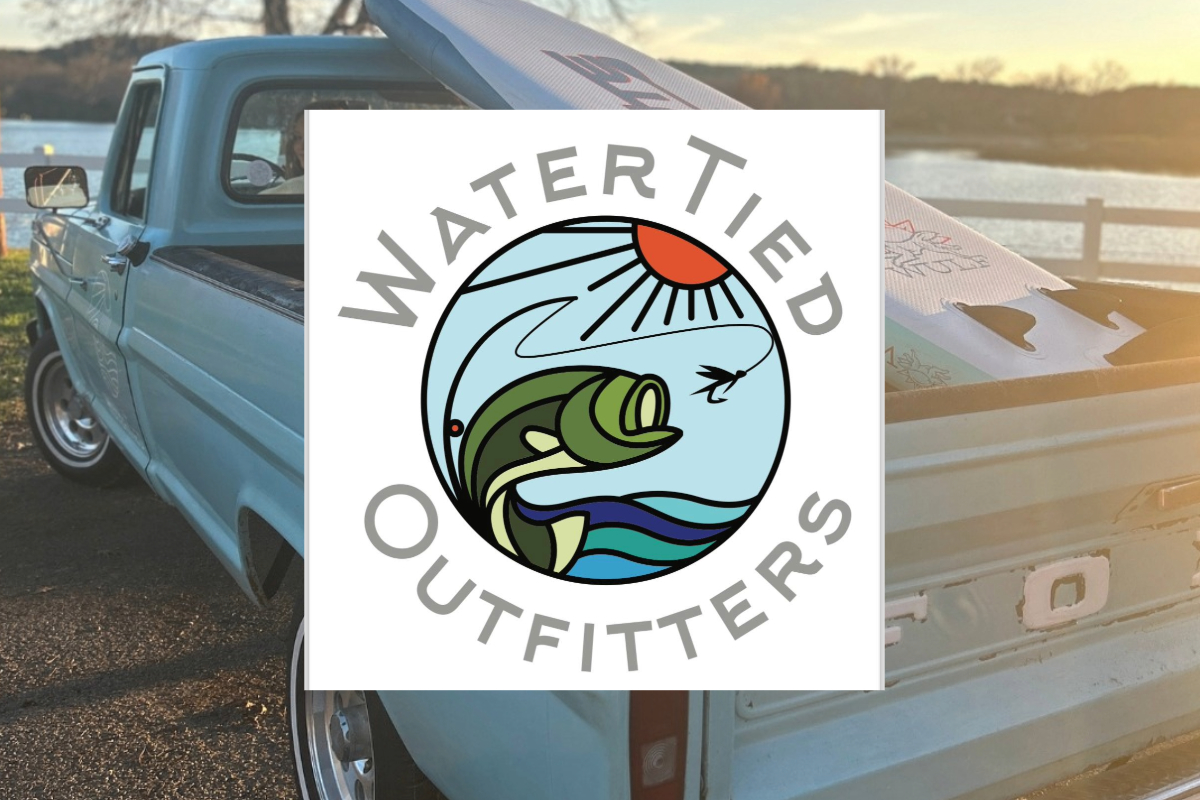 A blue vintage pickup truck parked by a lakeside at sunset, a paddleboard in the bed. Centered is the Water Tied Outfitters logo featuring a fish, waves, and a red sun, capturing the spirit of adventure and relaxation.