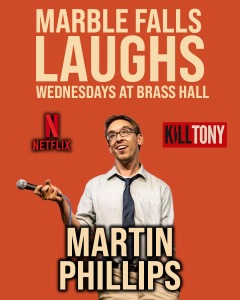 A man with glasses and a tie holds a microphone, smiling, on an orange background. Text reads: “Marble Falls Laughs Wednesdays at Brass Hall. Netflix. Kill Tony. Martin Phillips.”.