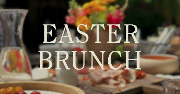 A table set with food, drinks, and flowers is blurred in the background, with the words EASTER BRUNCH in large white letters centered on the image.