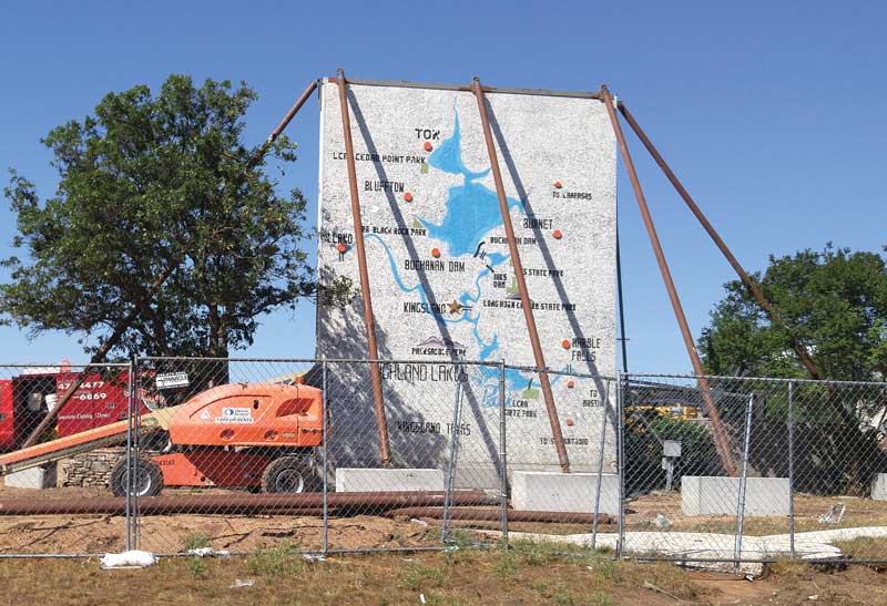 Steel pipes support the top of the mosaic-tile wall map of the Highland Lakes, which faces RR 1431 from the original Highland Lakes Shopping Center. Staff photo by Jennifer Fierro