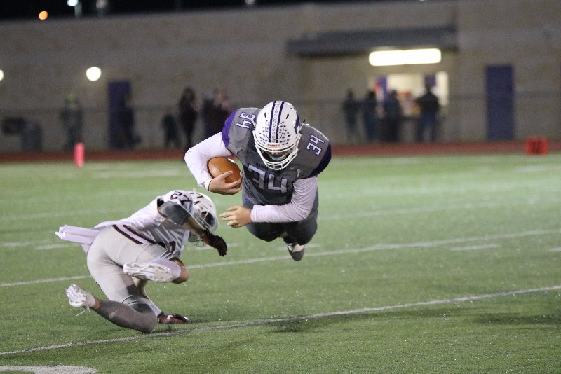 Marble Falls's Dillon Mayberry dives for extra yards during the Mustangs' 35-14 loss to Dripping Springs on Nov. 10. Photo by Luedecke Photography