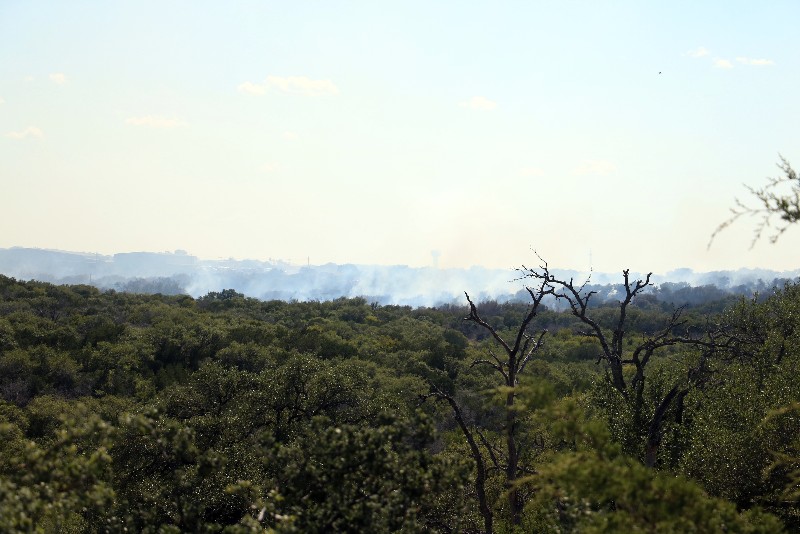 Looking west toward the Horseshoe Bay airport from Mountain Dew Road, smoke can be seen Aug. 25 from a 400-acre fire in the city limits. Residents in the area are being advised to evacuate to Quail Point Lodge. Staff photo by Jared Fields