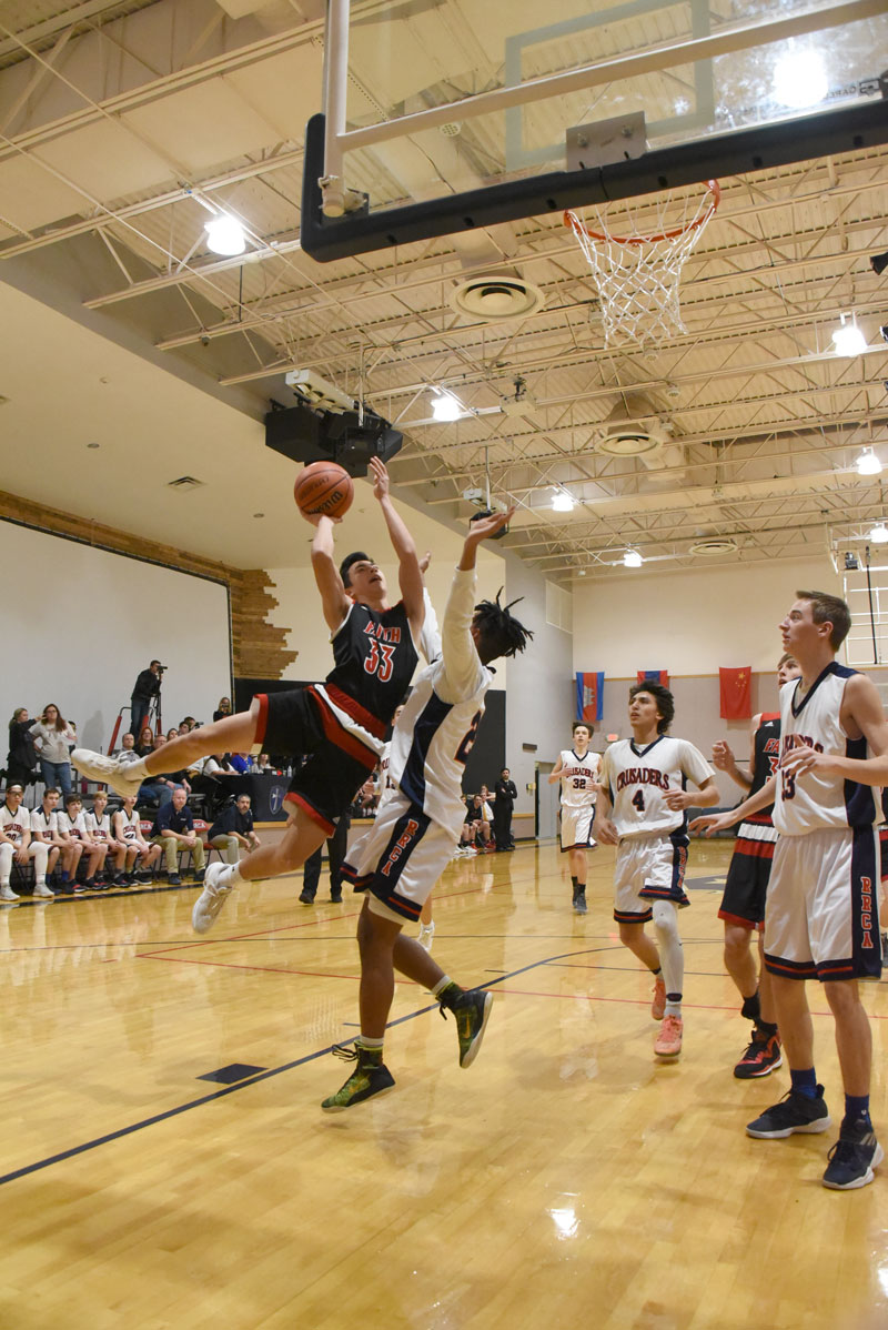 Faith Academy’s Tyler Kwan drives in for a shot during a game against the Round Rock Christian Crusaders. The Flames are in the playoffs with their first-round game on Friday, Feb. 15, against The Christian School of Castle Hills, 2216 Northwest Military Highway in San Antonio. Tipoff is at 7:15 p.m. Courtesy photo
